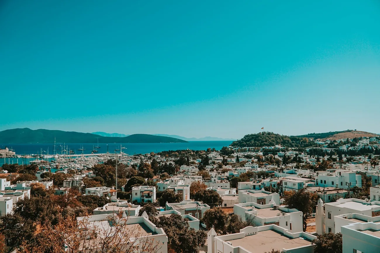 Hvite kubehus i Bodrum med marinaen og halvøya i bakgrunnen