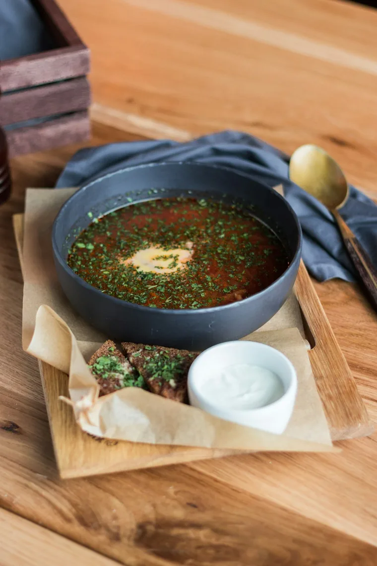 Suppe servert med brød ved siden av